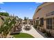 Relax in this backyard with a patio, synthetic grass, lounge swing and lush desert landscaping at 8934 E Calle Buena Vis, Scottsdale, AZ 85255