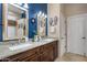 Bathroom with a double sink vanity, blue accent wall, and unique decorative towels at 8934 E Calle Buena Vis, Scottsdale, AZ 85255