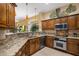 Well-lit kitchen featuring granite counters, stainless steel appliances, and views of the living area at 8934 E Calle Buena Vis, Scottsdale, AZ 85255