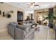 Spacious living room with gray sectional sofa, neutral walls, and access to outdoor patio at 8934 E Calle Buena Vis, Scottsdale, AZ 85255
