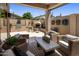 This beautiful outdoor patio features wicker furniture, a built-in grill, and a cozy fireplace at 8934 E Calle Buena Vis, Scottsdale, AZ 85255
