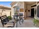 Inviting front patio with outdoor seating area, tiled floor, and decorative wall art at 8934 E Calle Buena Vis, Scottsdale, AZ 85255