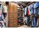 Walk-in closet providing ample storage with built in shelves, drawers, and clothing racks at 8934 E Calle Buena Vis, Scottsdale, AZ 85255
