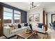 Open concept living room with stylish decor, a blue accent wall and large windows, providing ample natural light at 9331 S Mineros Dr, Apache Junction, AZ 85120