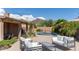 Outdoor living area features desert landscaping, comfortable seating and a pool with mountain views at 9477 E Rosemonte Dr, Scottsdale, AZ 85255