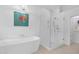 Luxurious bathroom showcasing a glass shower, modern tub, and stylish fixtures at 9477 E Rosemonte Dr, Scottsdale, AZ 85255