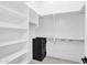 Walk-in closet with ample shelving and a secure safe for valuables at 9477 E Rosemonte Dr, Scottsdale, AZ 85255