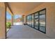 Covered patio with large sliding glass doors, seamlessly blending indoor and outdoor living at 9477 E Rosemonte Dr, Scottsdale, AZ 85255