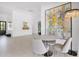 Open concept dining room with tile flooring, neutral seating and wet bar at 9477 E Rosemonte Dr, Scottsdale, AZ 85255