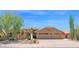 Warm Southwest home with a three car garage and mature desert landscaping at 9477 E Rosemonte Dr, Scottsdale, AZ 85255