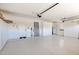 Spacious garage with epoxy flooring, custom storage cabinets, and ample parking space at 9477 E Rosemonte Dr, Scottsdale, AZ 85255