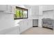 Bright kitchen with white countertops, stainless appliances, and a window view of lush greenery at 9477 E Rosemonte Dr, Scottsdale, AZ 85255
