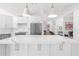 Spacious kitchen features a large marble island, stainless appliances, and modern pendant lighting at 9477 E Rosemonte Dr, Scottsdale, AZ 85255