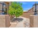 Landscaped front yard with a mature tree and a winding walkway at 9477 E Rosemonte Dr, Scottsdale, AZ 85255