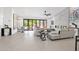 Modern living room with fireplace, tile floors and glass doors to backyard at 9477 E Rosemonte Dr, Scottsdale, AZ 85255