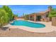 Beautiful pool with a Baja step, surrounded by lush landscaping and an outdoor kitchen at 9477 E Rosemonte Dr, Scottsdale, AZ 85255