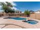 Beautiful backyard featuring a custom pool and spa and block fence for privacy at 10440 E Osage Ave, Mesa, AZ 85212