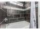 Bathroom with a tub, grey tile, showerhead, and built in shelf at 10440 E Osage Ave, Mesa, AZ 85212