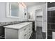 Bathroom featuring a double vanity, modern mirrors, and black tile accents at 10440 E Osage Ave, Mesa, AZ 85212