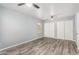 Bright bedroom features a ceiling fan, plank flooring and large closet at 10440 E Osage Ave, Mesa, AZ 85212