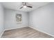 Neutral bedroom offers a ceiling fan, window and plank flooring at 10440 E Osage Ave, Mesa, AZ 85212
