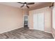Bedroom featuring neutral paint, plank flooring, and a large closet at 10440 E Osage Ave, Mesa, AZ 85212