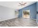 This bedroom features a ceiling fan and sliding glass doors to the outdoor patio at 10440 E Osage Ave, Mesa, AZ 85212