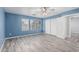 Spacious bedroom with ceiling fan, wood-look flooring, and ample closet space at 10440 E Osage Ave, Mesa, AZ 85212