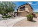 Inviting two-story home with a large driveway, two-car garage, and well-kept landscaping at 10440 E Osage Ave, Mesa, AZ 85212