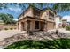 Beautiful two-story home with manicured lawn and desert landscape in front yard at 10440 E Osage Ave, Mesa, AZ 85212