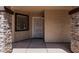 Inviting front porch with stone accents and security screen door at 10440 E Osage Ave, Mesa, AZ 85212