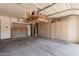 Spacious two car garage featuring built-in storage cabinets and an overhead lighting fixture at 10440 E Osage Ave, Mesa, AZ 85212