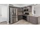 Modern kitchen featuring stainless steel appliances, dark cabinets, granite countertops, and light wood floors at 10440 E Osage Ave, Mesa, AZ 85212