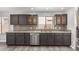 Stylish kitchen featuring dark cabinets, granite countertops, mosaic backsplash, and stainless steel appliances at 10440 E Osage Ave, Mesa, AZ 85212