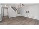 Bright living area with LVP flooring and staircase, and a ceiling fan at 10440 E Osage Ave, Mesa, AZ 85212