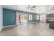 Open living area with LVP floors, sliding doors to the backyard, and modern ceiling fan at 10440 E Osage Ave, Mesa, AZ 85212