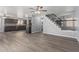 Open-concept living area with hardwood flooring and staircase access at 10440 E Osage Ave, Mesa, AZ 85212