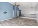 This living room features updated floors, paint, and a ceiling fan for comfort at 10440 E Osage Ave, Mesa, AZ 85212