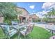 Spacious backyard with patio seating, lush turf, and ample space for outdoor gatherings at 10613 E Knowles Ave, Mesa, AZ 85209