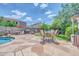 Spacious backyard with large tile patio, outdoor seating, grill, and mature landscaping at 10613 E Knowles Ave, Mesa, AZ 85209