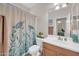 Clean bathroom with a turtle themed shower curtain, bright lighting, and mirrored vanity at 10613 E Knowles Ave, Mesa, AZ 85209