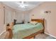 Cozy bedroom with a wooden bed frame, neutral walls, and golf equipment at 10613 E Knowles Ave, Mesa, AZ 85209
