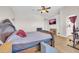 A lovely bedroom with a wooden bed frame, ceiling fan, and a TV on the wall at 10613 E Knowles Ave, Mesa, AZ 85209