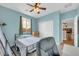 Cozy blue bedroom with a metal bed frame, white closet, and a sunny window at 10613 E Knowles Ave, Mesa, AZ 85209