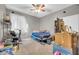 Messy bedroom with a grey wall color, a single bed, and a skeleton on the drawers at 10613 E Knowles Ave, Mesa, AZ 85209