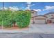 Two-story home with a three-car garage and mature desert landscaping on a sunny day at 10613 E Knowles Ave, Mesa, AZ 85209
