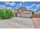 Charming two-story home featuring a spacious driveway and well-maintained front yard with desert landscaping at 10613 E Knowles Ave, Mesa, AZ 85209