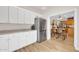 Bright open concept kitchen with stainless steel refrigerator and adjoining dining area at 10613 E Knowles Ave, Mesa, AZ 85209