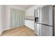 Modern kitchen with stainless steel refrigerator and white cabinets at 10613 E Knowles Ave, Mesa, AZ 85209