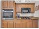 Kitchen area showcasing built-in oven and microwave, granite countertops, and gas range at 10613 E Knowles Ave, Mesa, AZ 85209